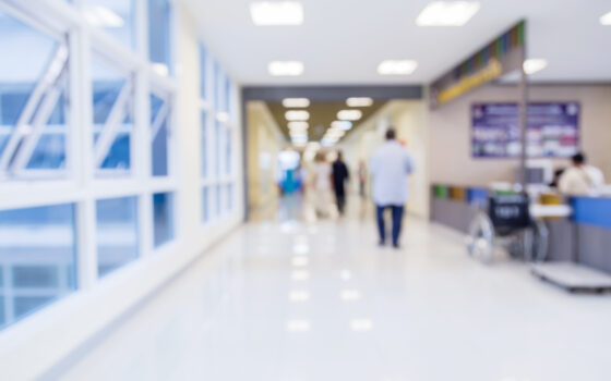 Blurred image of a hospital corridor representing emergency care